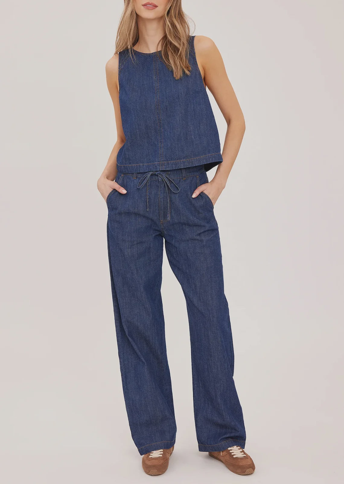 Hayden high-rise barrel-leg pants in washed denim, featuring slash pockets, a front zipper closure, and an elasticated back waistband. Made from a cotton-linen blend for a relaxed, lived-in look.