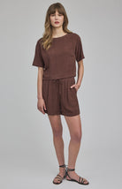 High-rise Juno shorts in a lightweight rayon-linen blend featuring an elastic drawstring waistband, front slash pockets, back patch pockets, and a relaxed fit.