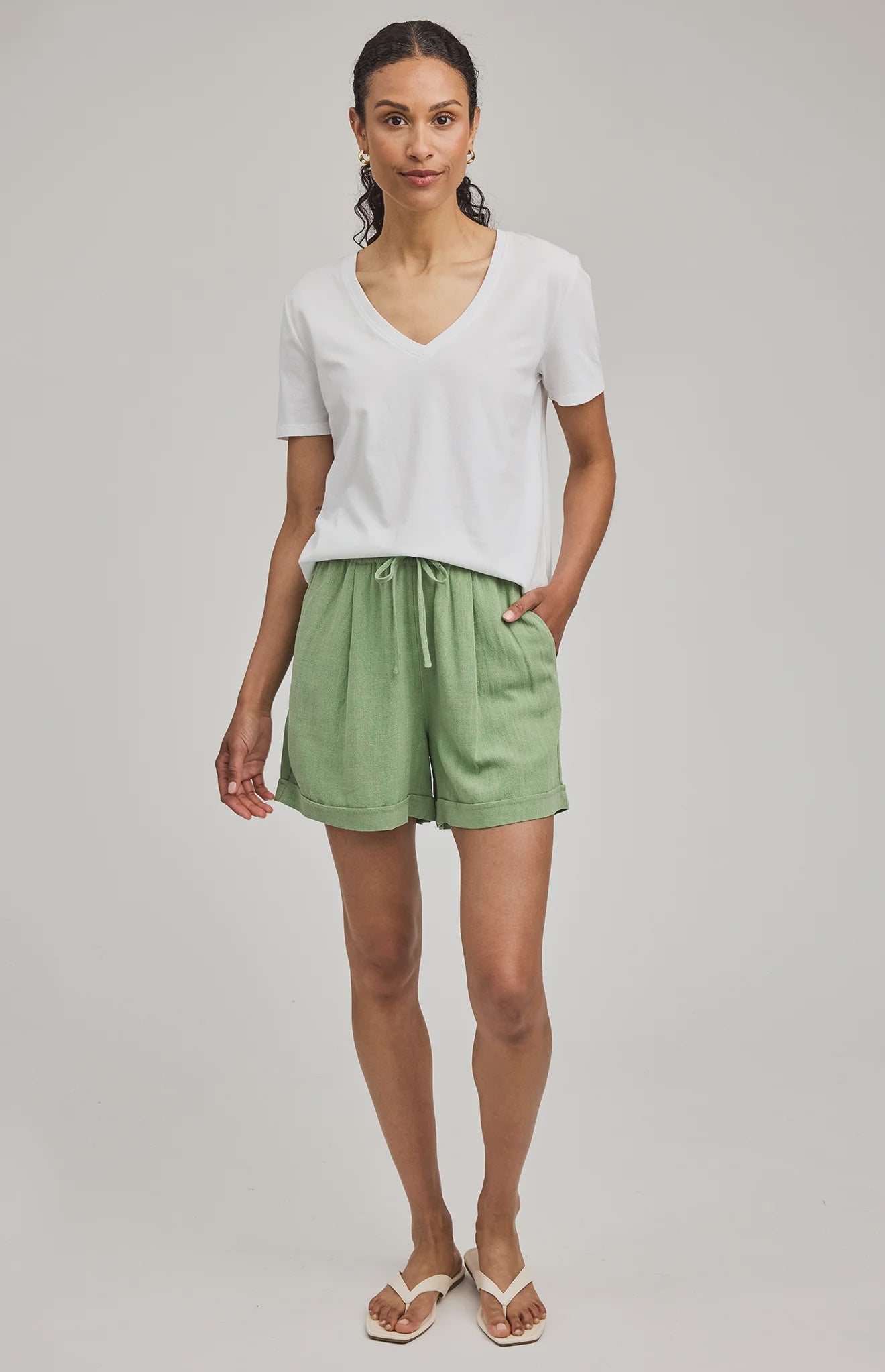High-rise Juno shorts in a lightweight rayon-linen blend featuring an elastic drawstring waistband, front slash pockets, back patch pockets, and a relaxed fit.