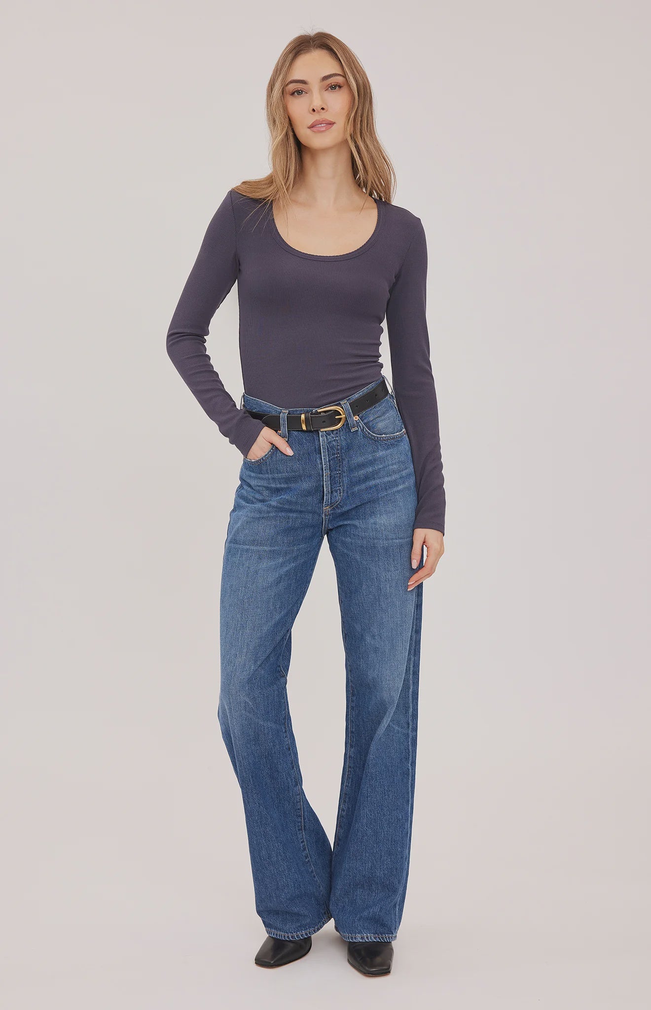 Lexy top in a stretchy ribbed fabric with a body-hugging contour fit, scoop neckline, and delicate scalloped edge for a feminine finish. Available in Black and Smoke.