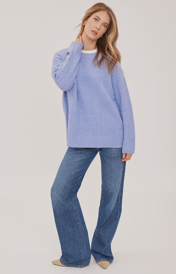 Lori sweater in a cozy heathered knit with a classic crew neckline, oversized fit, and allover cable knit detailing for a textured finish.