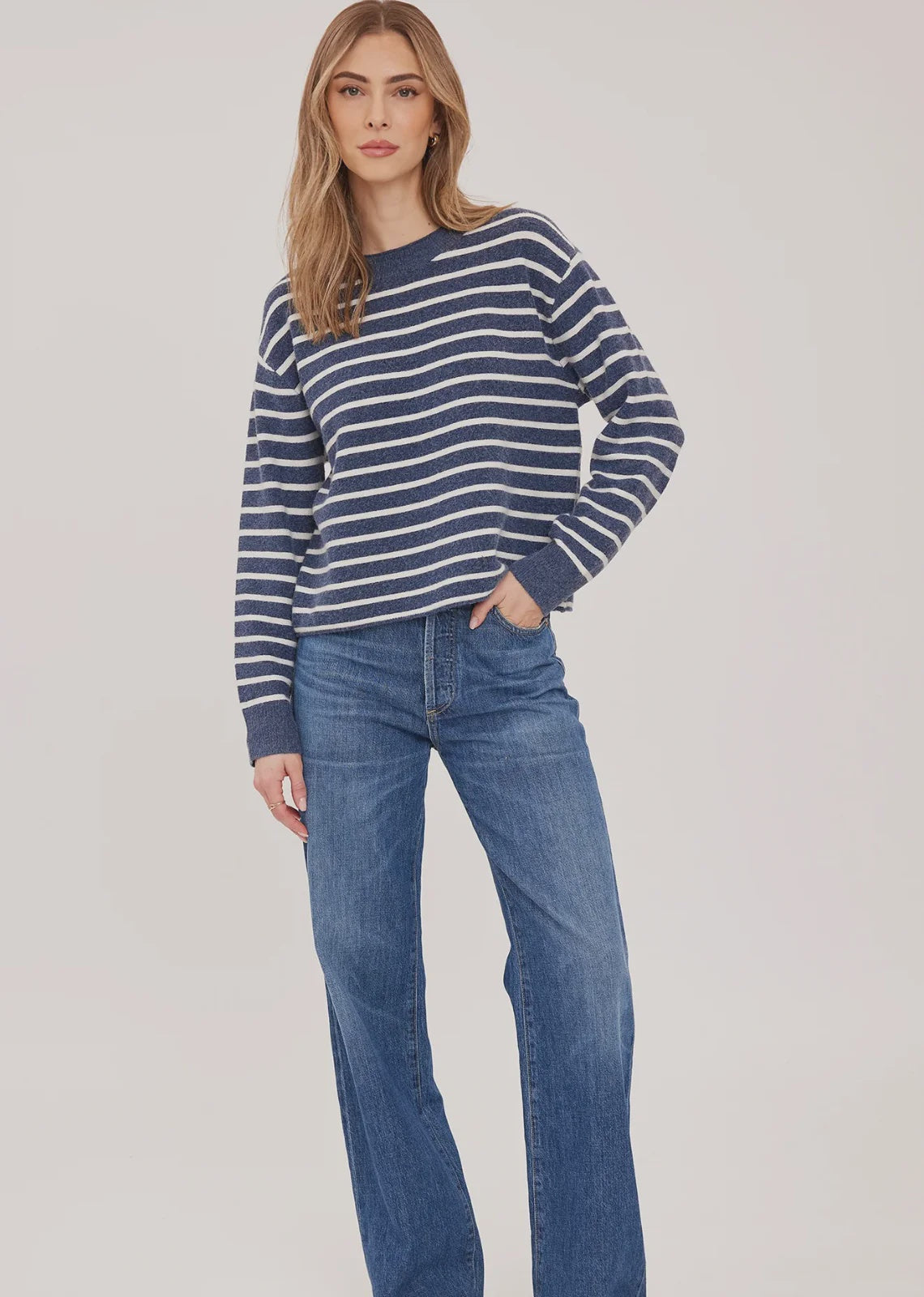 Wanda relaxed-fit sweater in navy with white stripes made from soft, brushed yarn, featuring rolled edges at the neckline and hem for an effortless, casual look.