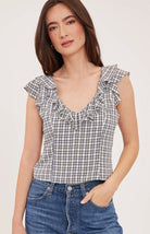 Women's black sleeveless tank top in a lightweight mini check fabric featuring a delicate flounce neckline, a relaxed fit, and a feminine silhouette.