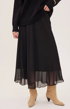 Arianna bias-cut chiffon skirt with a flattering high-rise fit, soft fluid drape, and an elastic waistband finished with delicate scalloped trim. Fully lined for comfortable wear and available in Smoke and Black.