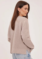 Axel oversized sweater in a soft waffle-knit yarn, featuring a crew neckline, exposed seam details, and side slits for a relaxed, textured look.