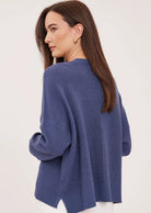 Axel oversized sweater in a soft waffle-knit yarn, featuring a crew neckline, exposed seam details, and side slits for a relaxed, textured look.