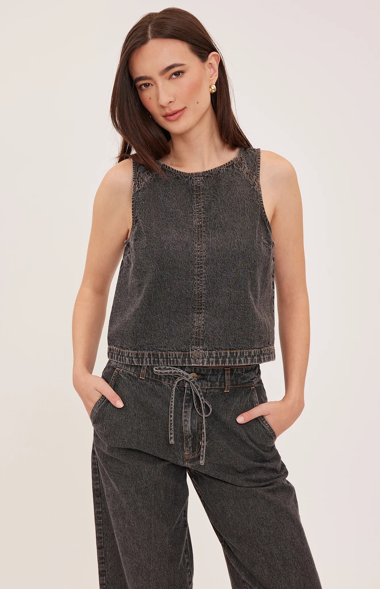 Blaise denim tank top with a lived-in wash, contrast topstitching details, and a back keyhole closure.