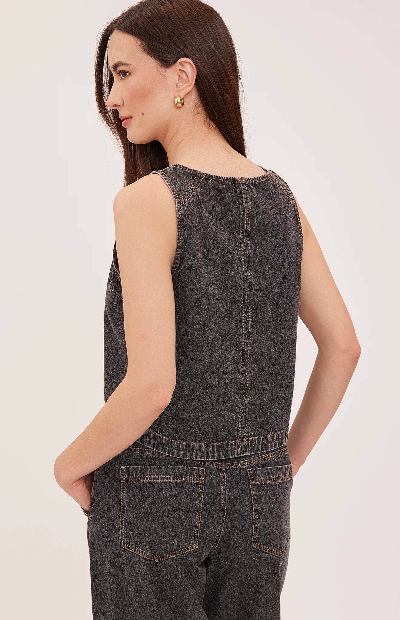 Blaise denim tank top with a lived-in wash, contrast topstitching details, and a back keyhole closure.