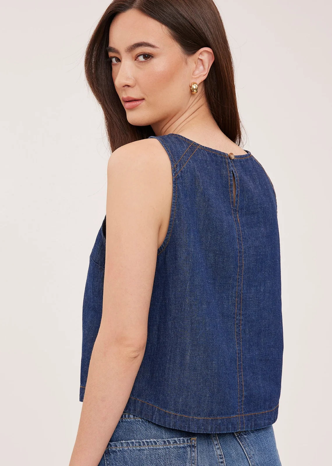 Blaise denim tank top in washed denim with contrast topstitching details and a back keyhole closure, designed for a relaxed, lived-in look.