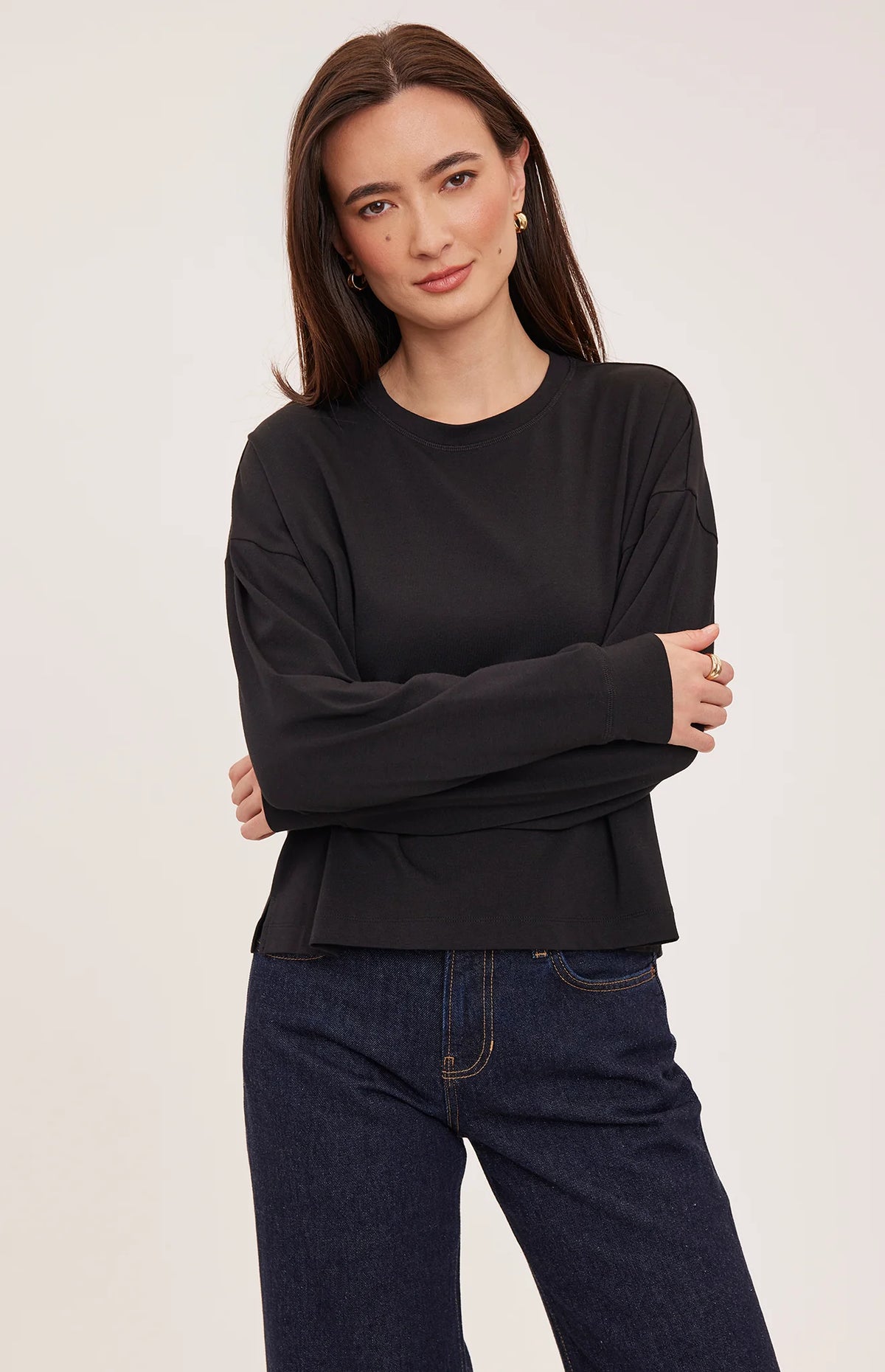 Easton top in a soft cotton-modal blend with a classic crew neckline, oversized fit, and side slit details for added movement. Available in Black and Cream.