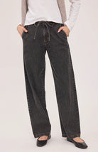 Hayden high-rise barrel-leg pants in washed denim, featuring slash pockets, a front zipper closure, and an elasticated back waistband. Made from a cotton-linen blend for a relaxed, lived-in look.