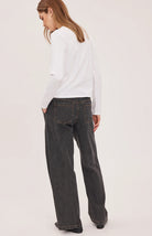 Hayden high-rise barrel-leg pants in washed denim, featuring slash pockets, a front zipper closure, and an elasticated back waistband. Made from a cotton-linen blend for a relaxed, lived-in look.
