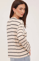 Women's relaxed long sleeve top featuring cream and soft beige stripes, a classic crew neckline, side slits, and a lightweight rayon jersey knit.