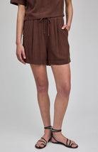 High-rise Juno shorts in a lightweight rayon-linen blend featuring an elastic drawstring waistband, front slash pockets, back patch pockets, and a relaxed fit.