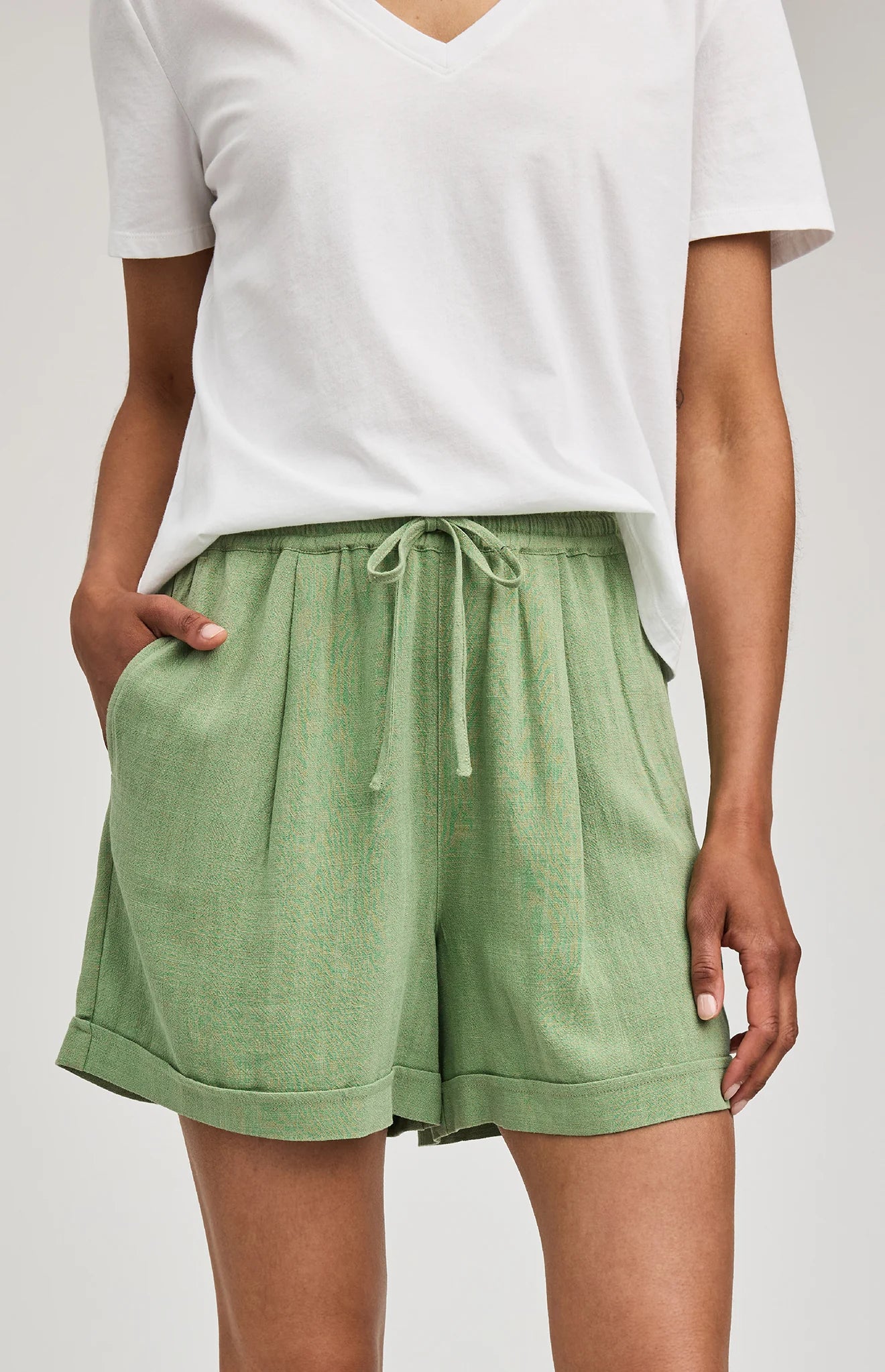 High-rise Juno shorts in a lightweight rayon-linen blend featuring an elastic drawstring waistband, front slash pockets, back patch pockets, and a relaxed fit.