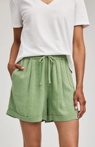 High-rise Juno shorts in a lightweight rayon-linen blend featuring an elastic drawstring waistband, front slash pockets, back patch pockets, and a relaxed fit.