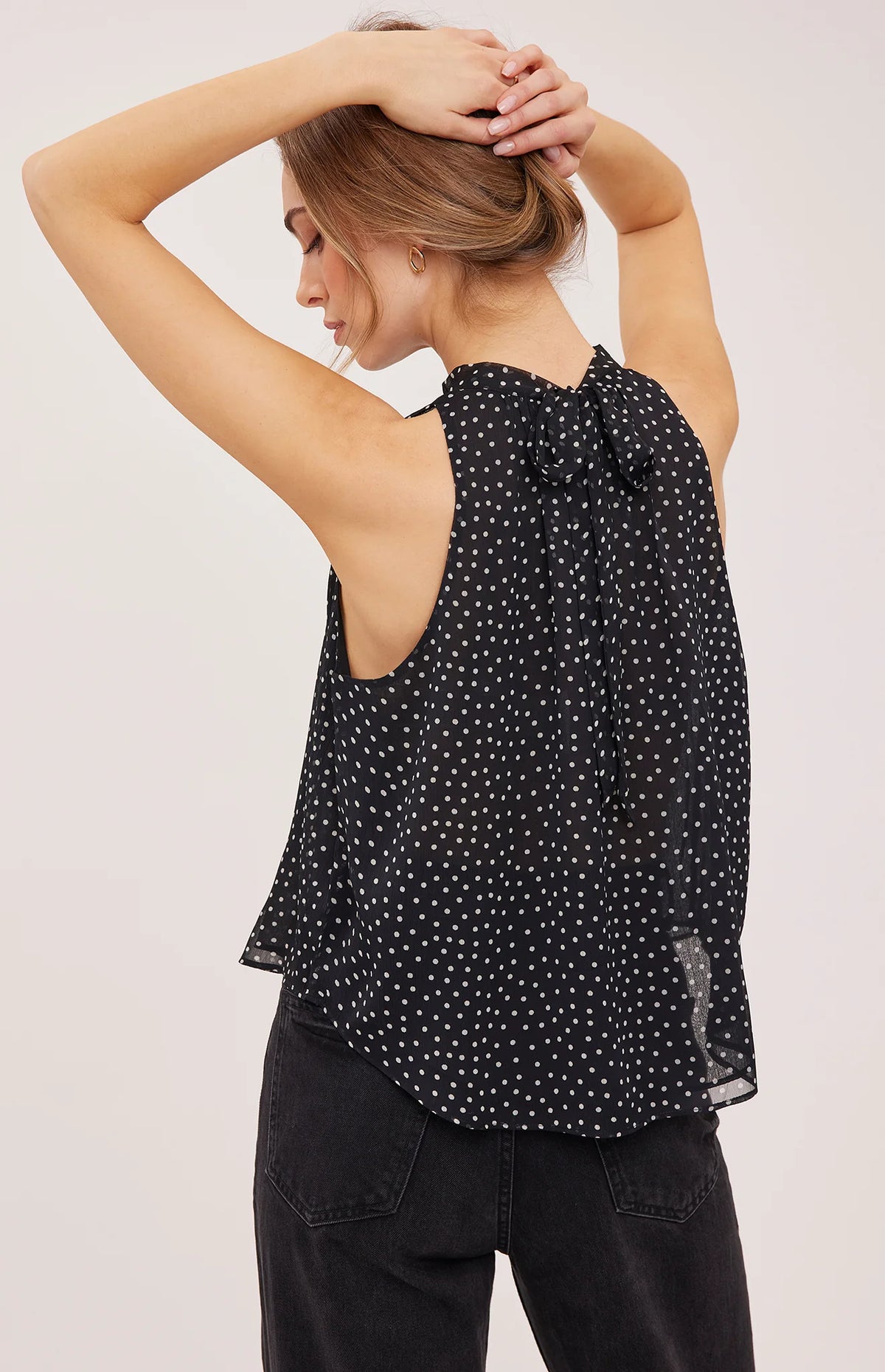 Lenora blouse in crinkled chiffon with a mock neckline, long sleeves, and a feminine back tie detail. Fully lined for comfortable wear and available in Black Print and Cream Print.