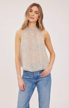 Lenora blouse in crinkled chiffon with a mock neckline, long sleeves, and a feminine back tie detail. Fully lined for comfortable wear and available in Black Print and Cream Print.