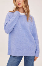 Lori sweater in a cozy heathered knit with a classic crew neckline, oversized fit, and allover cable knit detailing for a textured finish.