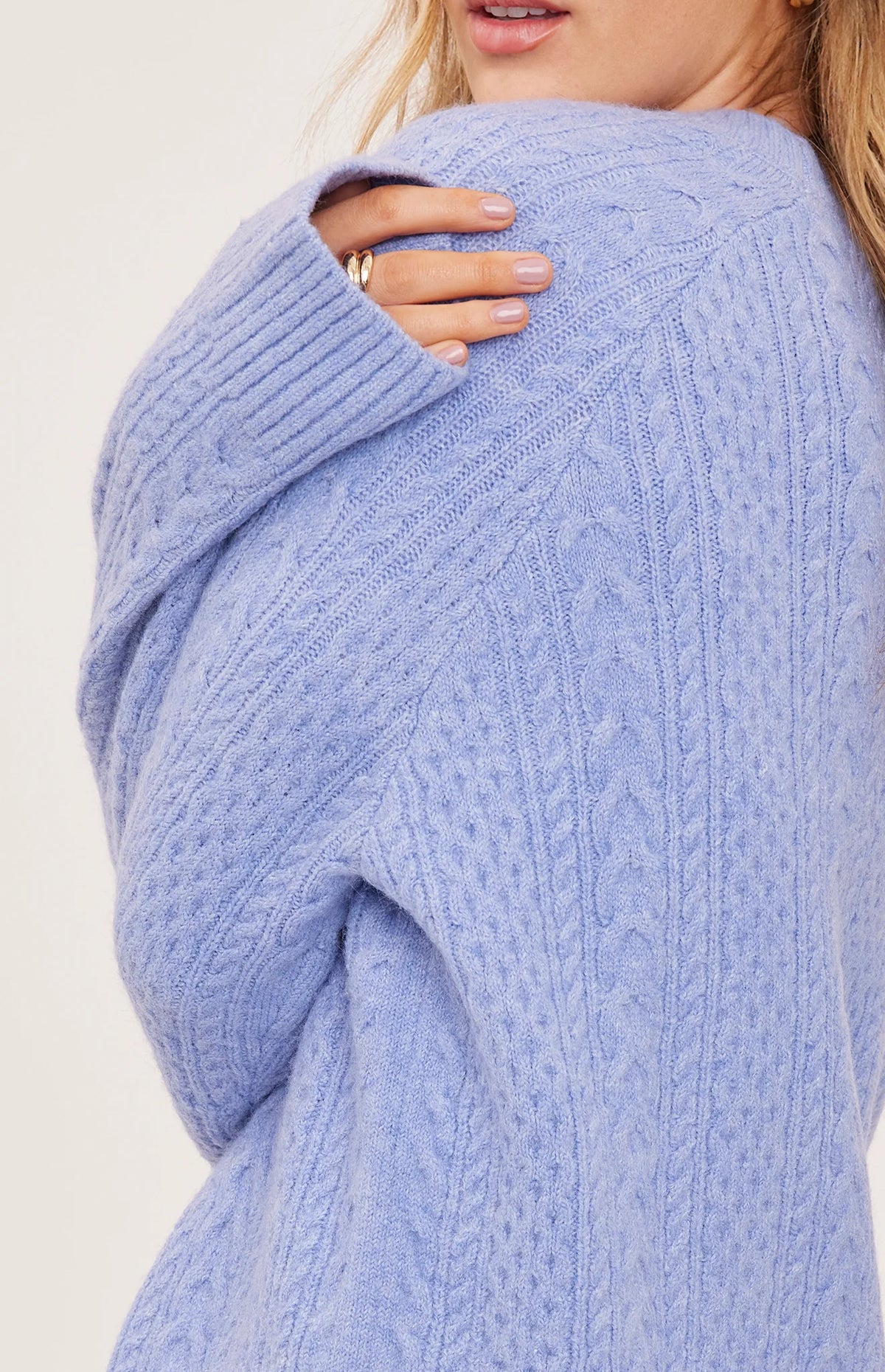 Lori sweater in a cozy heathered knit with a classic crew neckline, oversized fit, and allover cable knit detailing for a textured finish.
