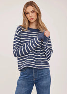 Wanda relaxed-fit sweater in navy with white stripes made from soft, brushed yarn, featuring rolled edges at the neckline and hem for an effortless, casual look.