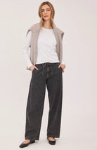 Hayden high-rise barrel-leg pants in washed denim, featuring slash pockets, a front zipper closure, and an elasticated back waistband. Made from a cotton-linen blend for a relaxed, lived-in look.