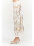 Harper Floral Midi Skirt in soft yellow and cream featuring a delicate floral print, smooth satin finish, white lace panel detailing, and a flowing midi-length silhouette.