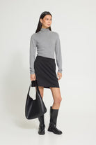 Mini skirt featuring a fitted waist, clean straight silhouette, and smooth soft-touch finish.