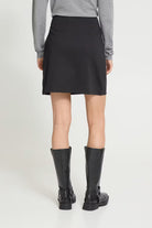Mini skirt featuring a fitted waist, clean straight silhouette, and smooth soft-touch finish.