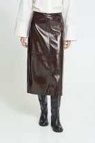 Brown High-waisted midi skirt featuring a straight silhouette, glossy textured finish, subtle panel stitching, and an exposed back zipper for a sleek, modern look.