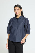 Washed dark blue cotton shirt featuring a straight silhouette, voluminous elbow-length sleeves, classic collar, concealed front button placket, and a soft textured finish for a relaxed yet polished look.