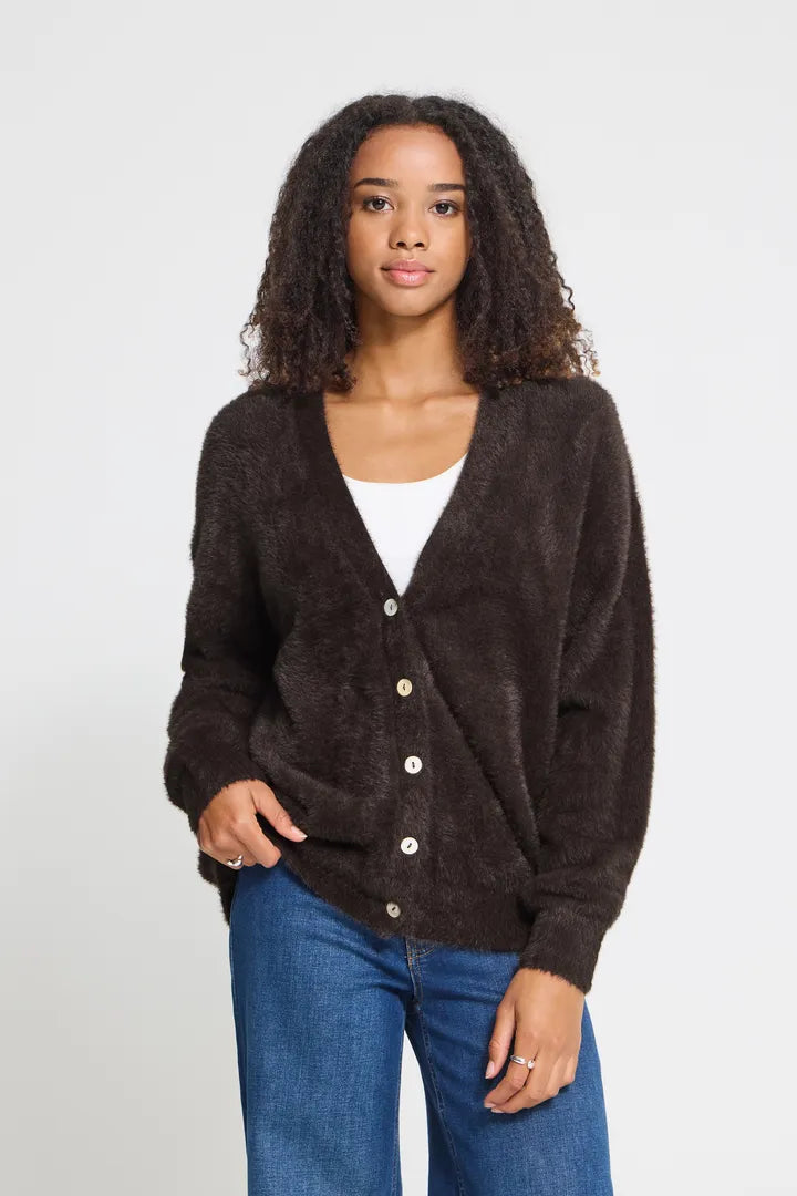 Knit cardigan in a light Cloud Dancer shade featuring a relaxed fit, long sleeves, and a button-front closure with a cozy textured finish.
