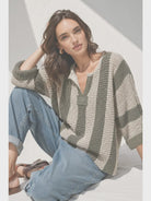 Loose, slouchy fit with a cropped length, V-neckline, 3/4 sleeves, vertical stripe design, and solid front and back patch detailing.