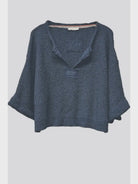 Lora chunky cropped sweater with a loose slouchy fit, V-neckline, relaxed ¾ sleeves, and contrasting solid patch details on the front and back.