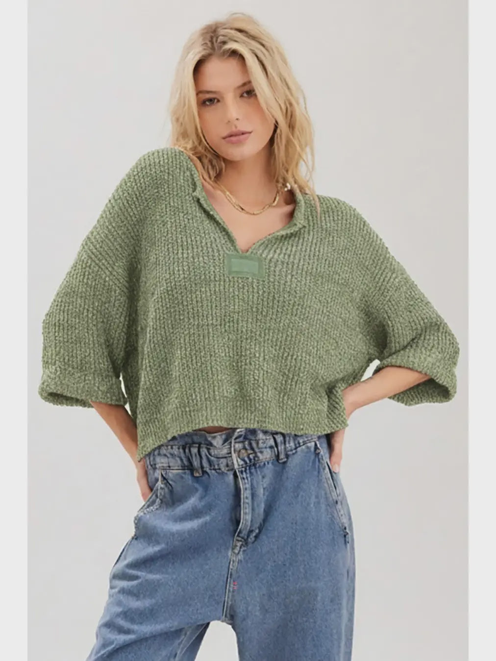 Lora chunky cropped sweater with a loose slouchy fit, V-neckline, relaxed ¾ sleeves, and contrasting solid patch details on the front and back.