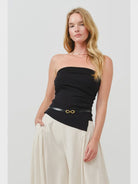 woman wearing a strapless ruched side top in black also available in lemon and cream