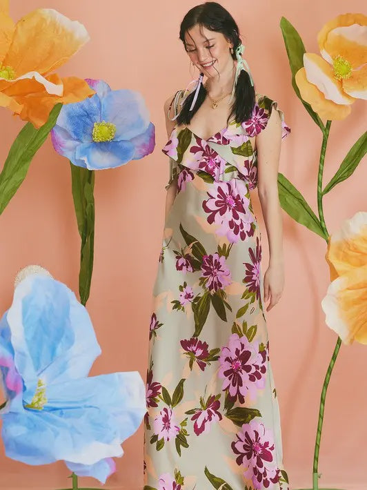 woman wearing floral sage satin maxi dress with ruffle detailing