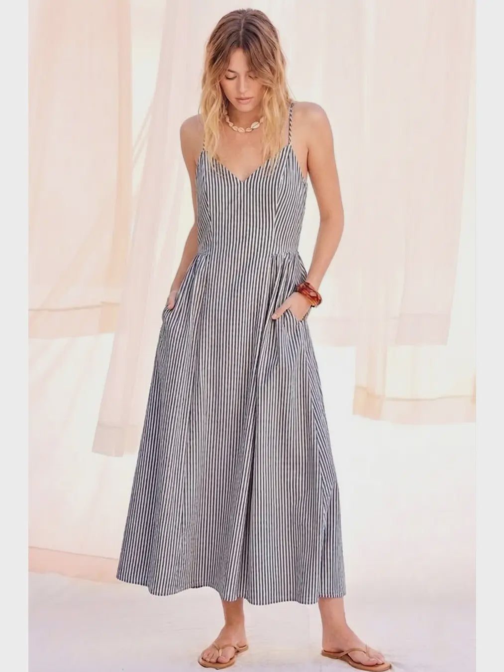 woman wearing a navy striped maxi dress with a v neck