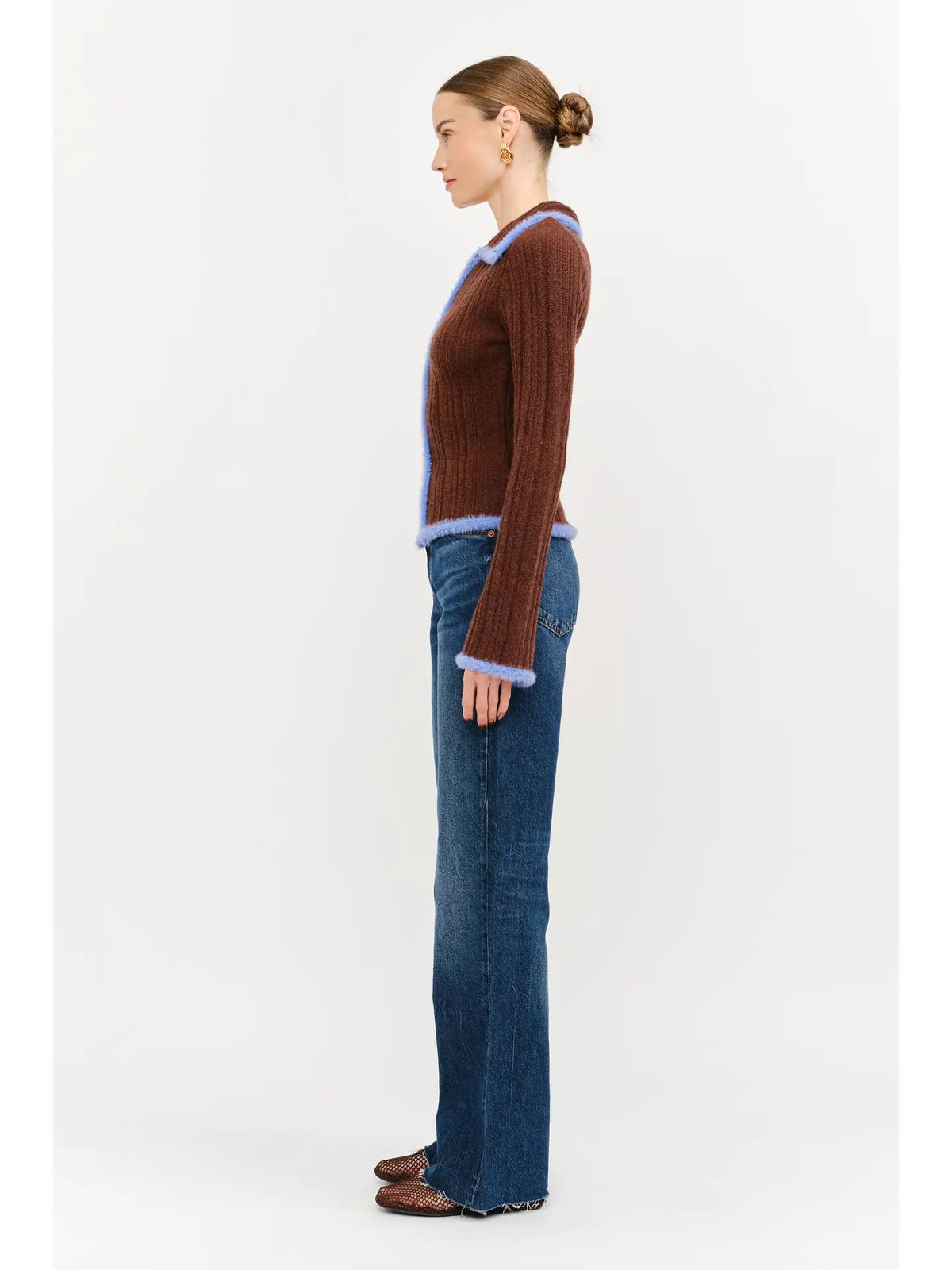 Model wearing the Jacquie Knit Top in brown, featuring a fitted silhouette, long sleeves, collared neckline, contrasting blue fuzzy trim, and two-way front zipper closure.