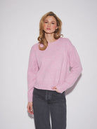 Relaxed-fit crewneck sweater in a soft knit fabric, featuring long sleeves, ribbed cuffs and hem, and a slightly cropped length
