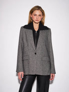 John & Jenn Hayes Blazer featuring a classic herringbone pattern, structured fit, elongated silhouette, and subtle texture for a polished, menswear-inspired look.
