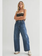 Dark denim barrel-leg jeans with an extra-wide silhouette, high rise, statement seam detailing, subtle whiskering, and silver hardware.
