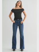 Dark denim mid-rise flare jeans with a fitted waist, hips, and thighs and a full-length leg that opens into a sleek, flattering flare.
