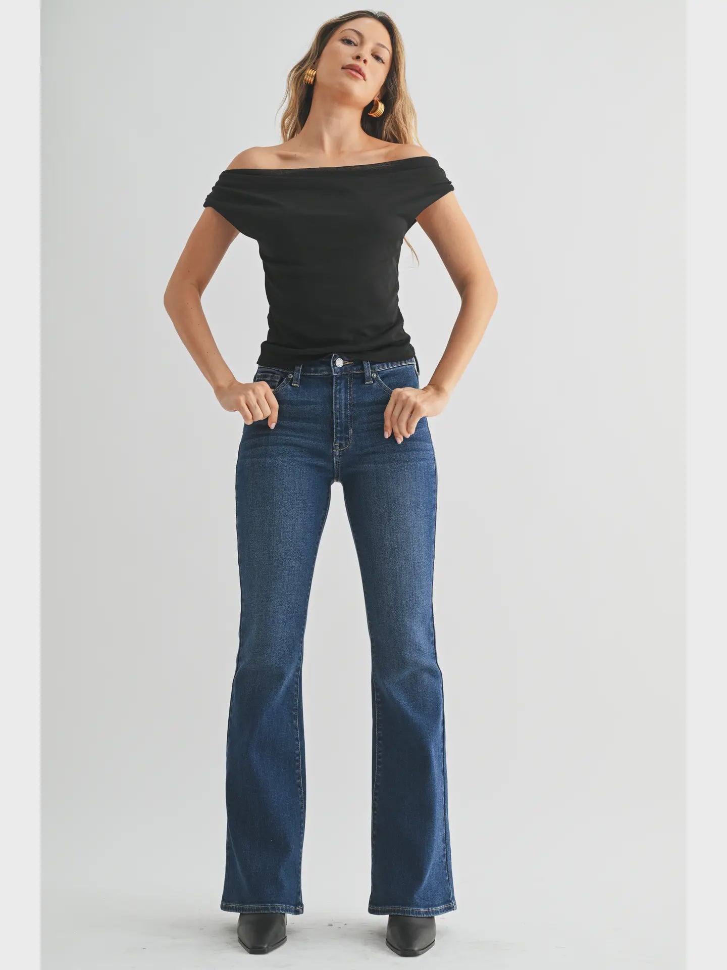 Dark denim mid-rise flare jeans with a fitted waist, hips, and thighs and a full-length leg that opens into a sleek, flattering flare.
