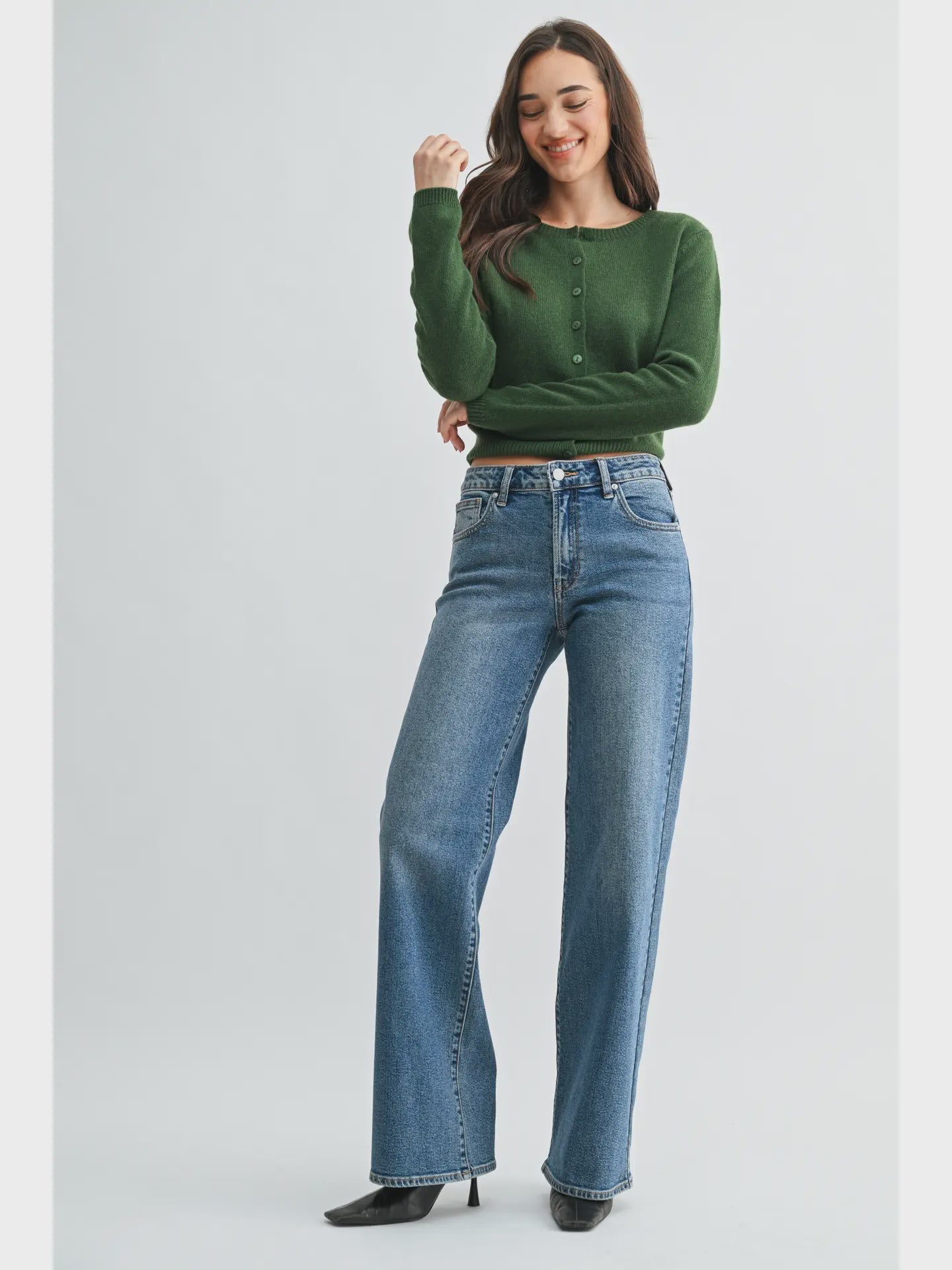 woman wearing a medium wash wide leg jean with a 33 inch inseam