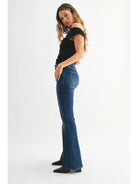 Dark denim mid-rise flare jeans with a fitted waist, hips, and thighs and a full-length leg that opens into a sleek, flattering flare.
