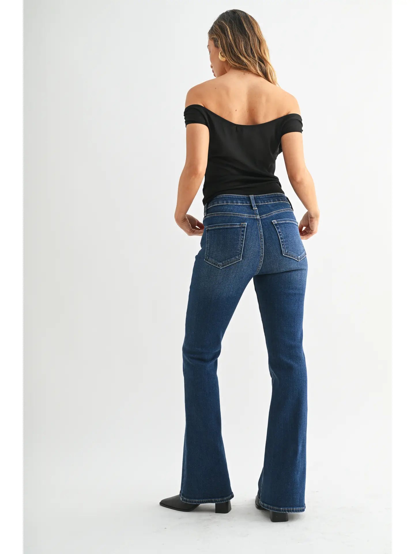 Dark denim mid-rise flare jeans with a fitted waist, hips, and thighs and a full-length leg that opens into a sleek, flattering flare.
