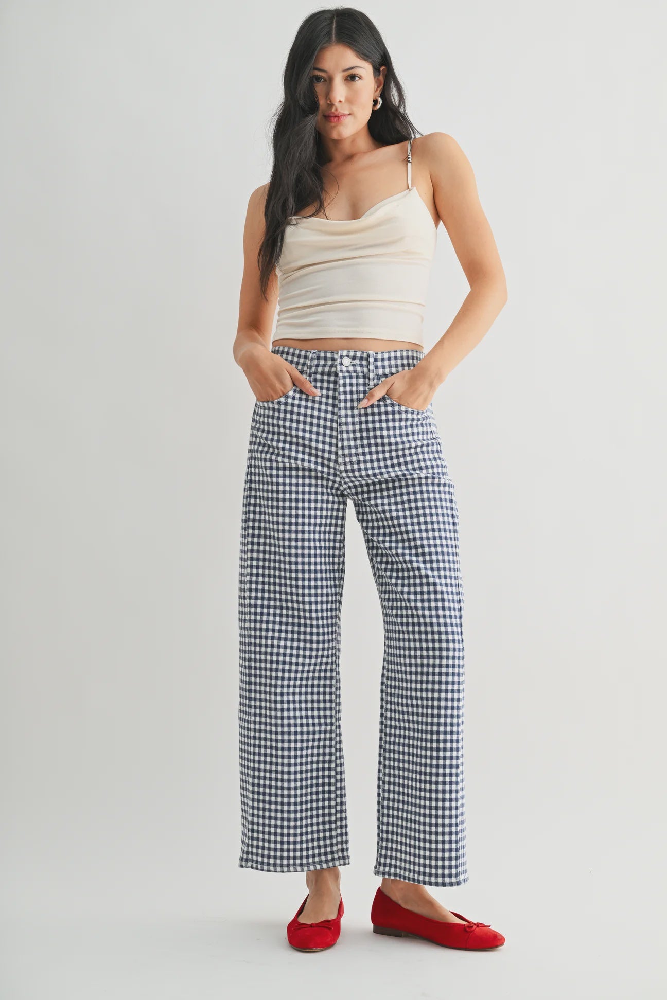 woman wearing an ankle length barrel jean in a navy and white ginham print