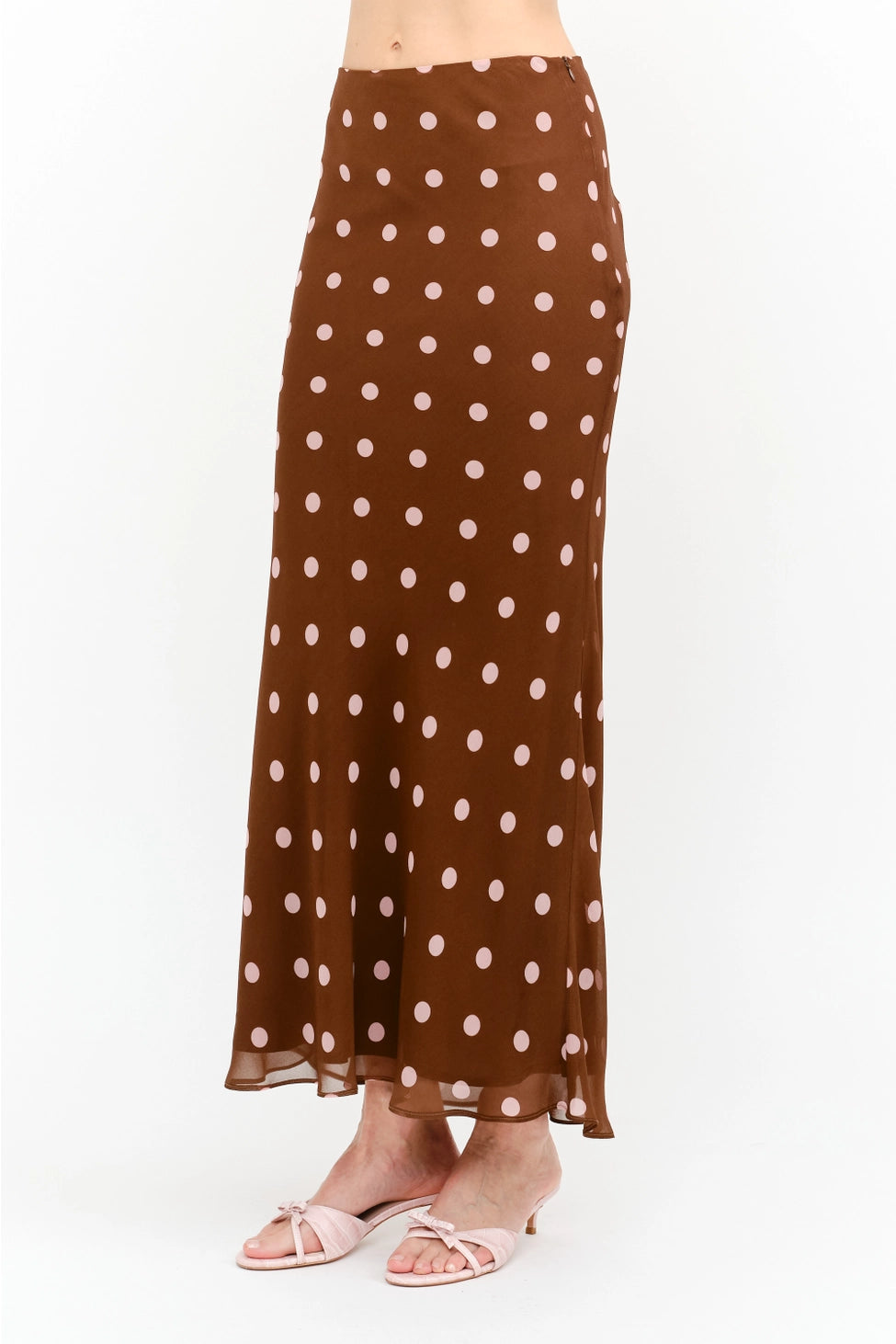 Kalila Midi Skirt in rich brown featuring soft pink polka dots, a flattering mermaid silhouette, and a flowing ankle-grazing hem.