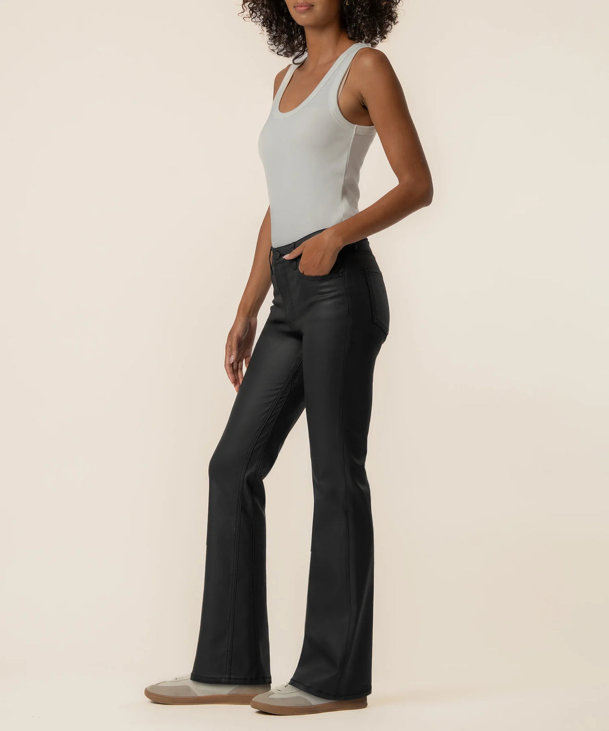 High-rise kick flare pants in Matte Black featuring a sleek coated finish, Fab Ab front pockets, inset leg detailing, and a flattering flared silhouette.